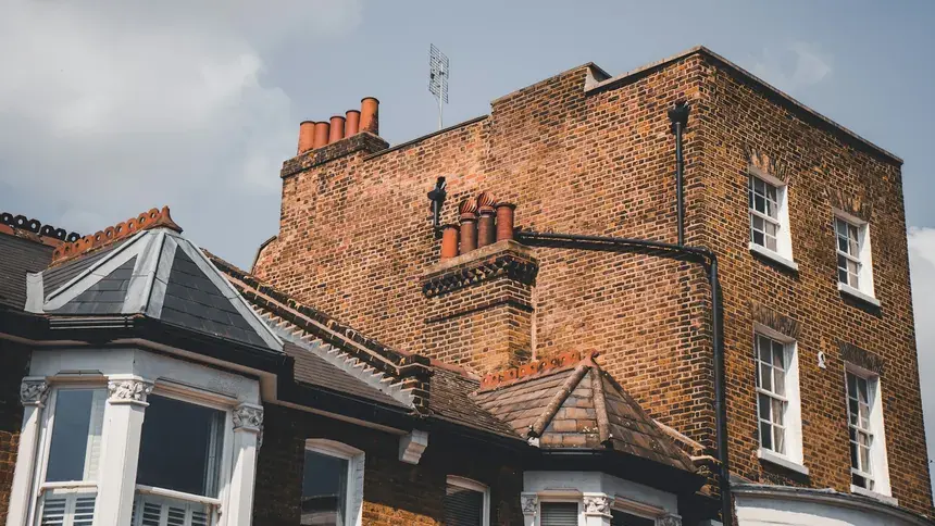 Rows of brick terraced homes with pitched roofs and chimneys in Rainham