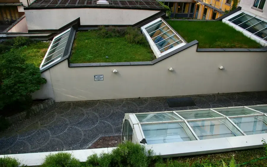 After: a seamless modern flat roof with roof lights over a finished extension