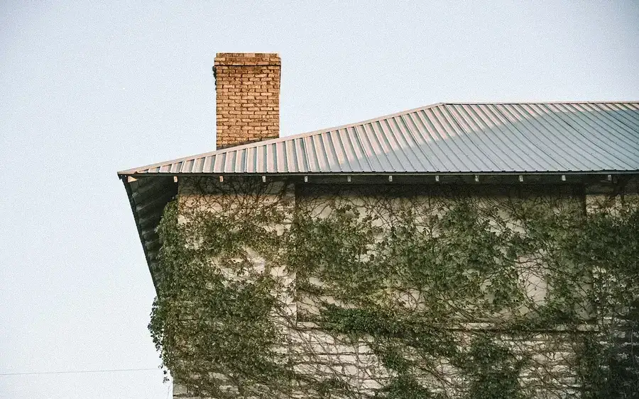 Before: worn, mossy concrete roof tiles on a post-war semi