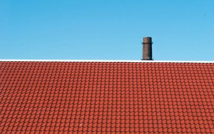 After: a repaired, secure tiled roof restored to a clean, watertight finish